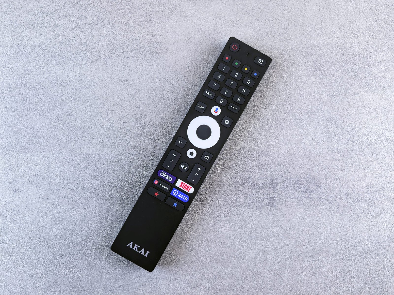 Amazon Fire TV Stick HD (2025) with Alexa voice remote, plugged into a smart TV showing live TV apps like YouTube, Prime Video, and Zee5 interface