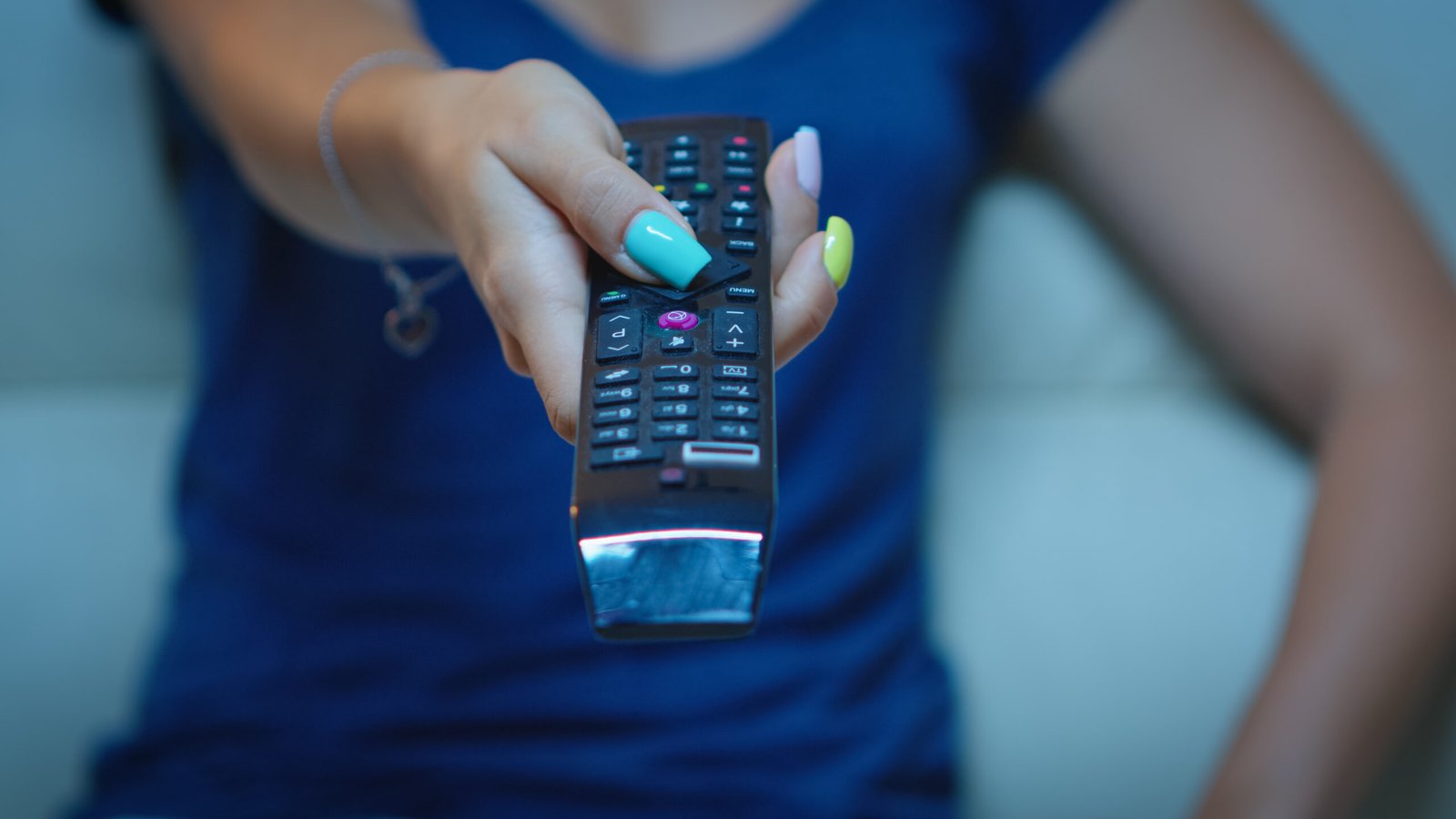 "Fire TV Stick placed next to a TV showing streaming apps like Netflix and Prime Video"